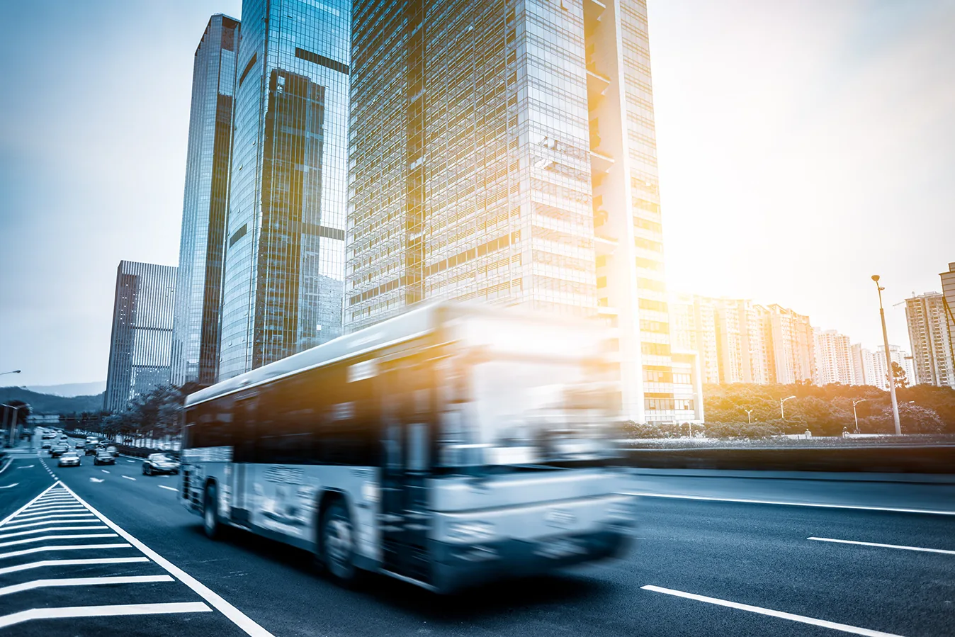 Blurred motion of road and buildings against sky